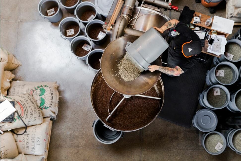 Loading the raw green beans into the hopper at Sightglass Coffee